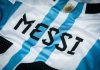 A white and light blue striped jersey with the name MESSI printed in black