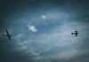 Two aircraft flying in a cloudy sky