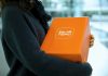 Woman holding an orange temu package