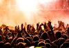 people raising their hands on concert
