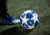 blue and white soccer ball on green grass field