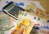 Euro and Romanian Lei currency with calculator on a financial desk setup.