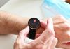 A person checking a heart rate monitor on a smartwatch on their wrist