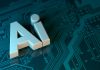 The letters AI in white 3D block font on a dark teal circuit board